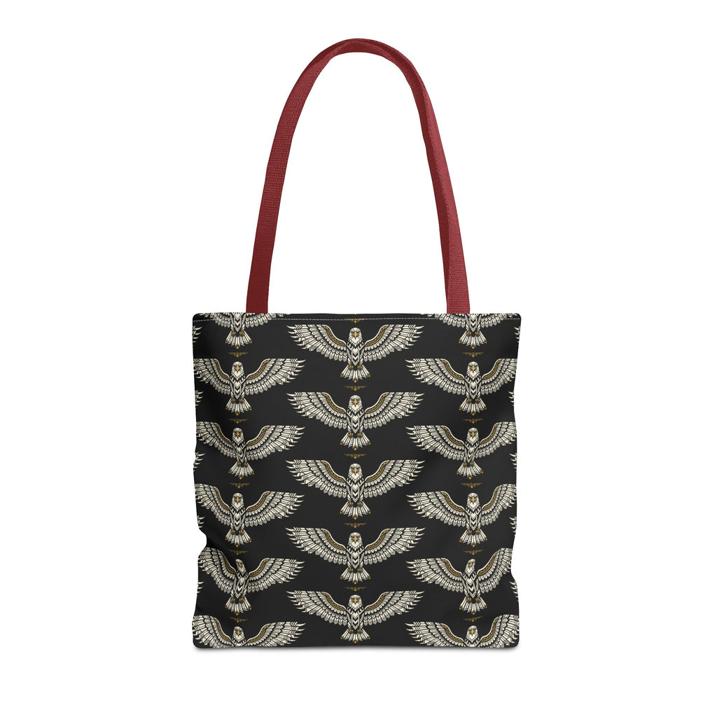 Tote bag with black fabric and repeating gold winged scarab pattern, red handles