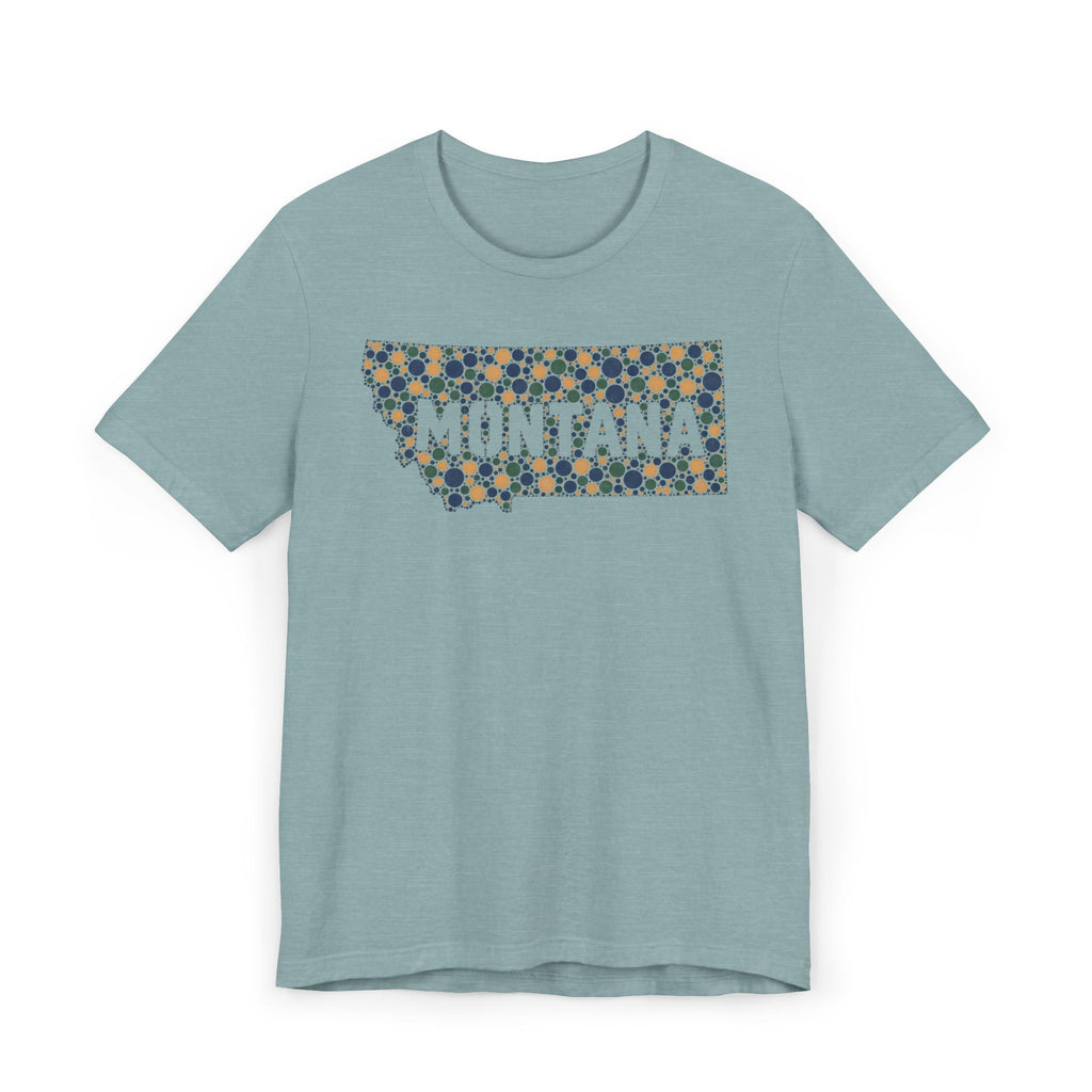 Light blue crewneck t-shirt with “MONTANA” mosaic floral outline graphic on front.