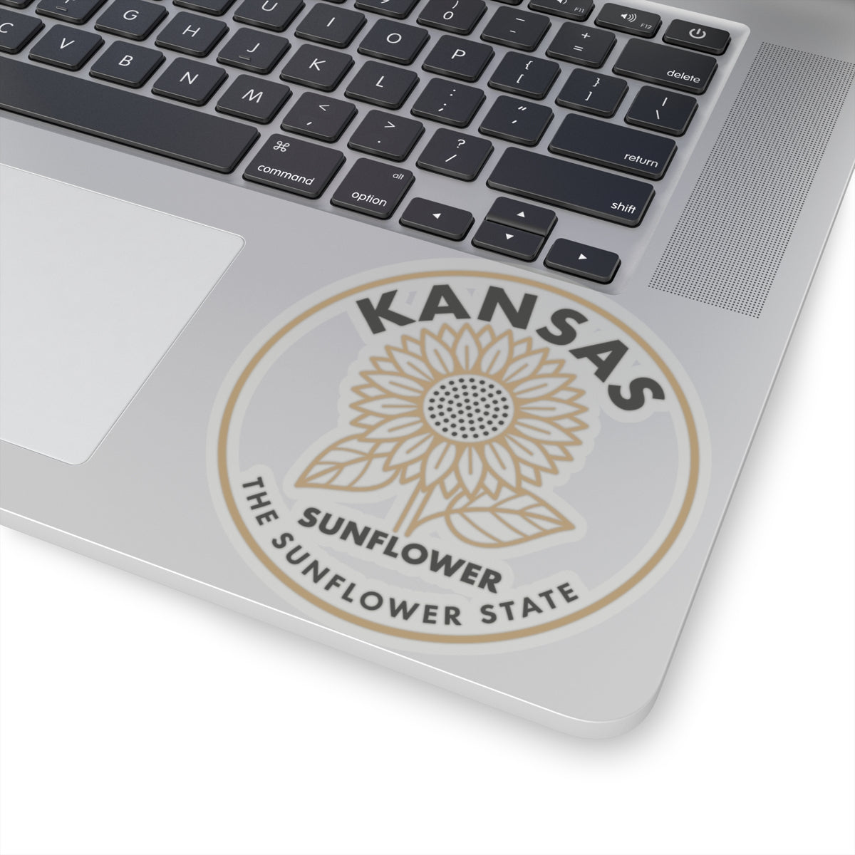 Circular vinyl decal featuring Kansas sunflower and text, beige and gray on white