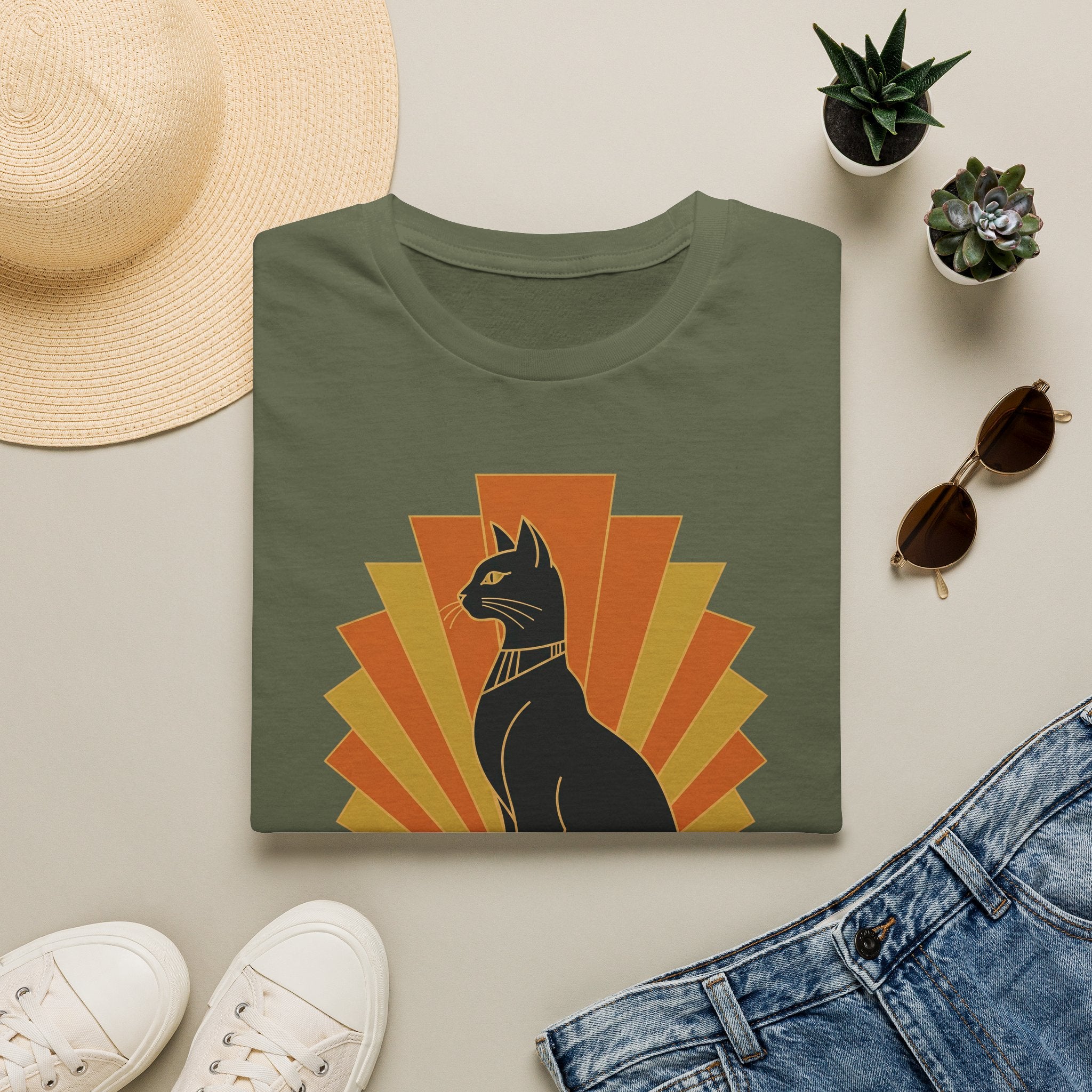 Olive green T-shirt with black Egyptian cat headdress, orange sunburst front graphic.