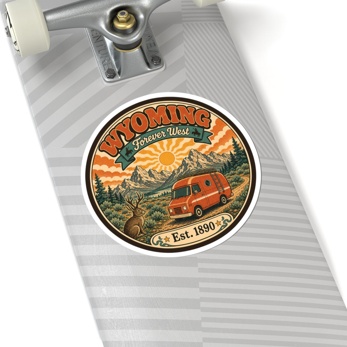 Round kiss-cut sticker featuring Wyoming Forever West artwork with orange van and Est. 1890