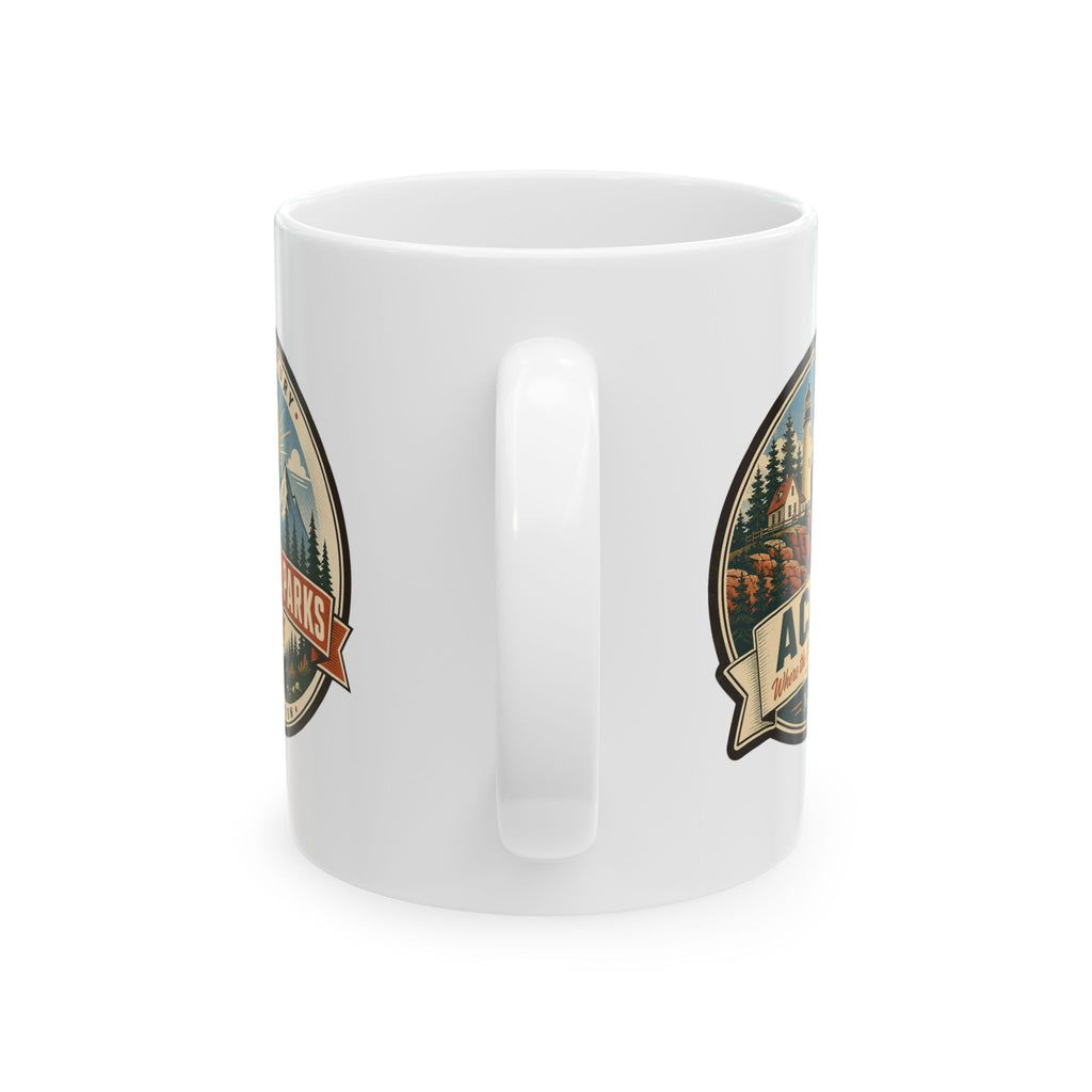 White ceramic coffee mug with side badge graphic and vertical handle detail.