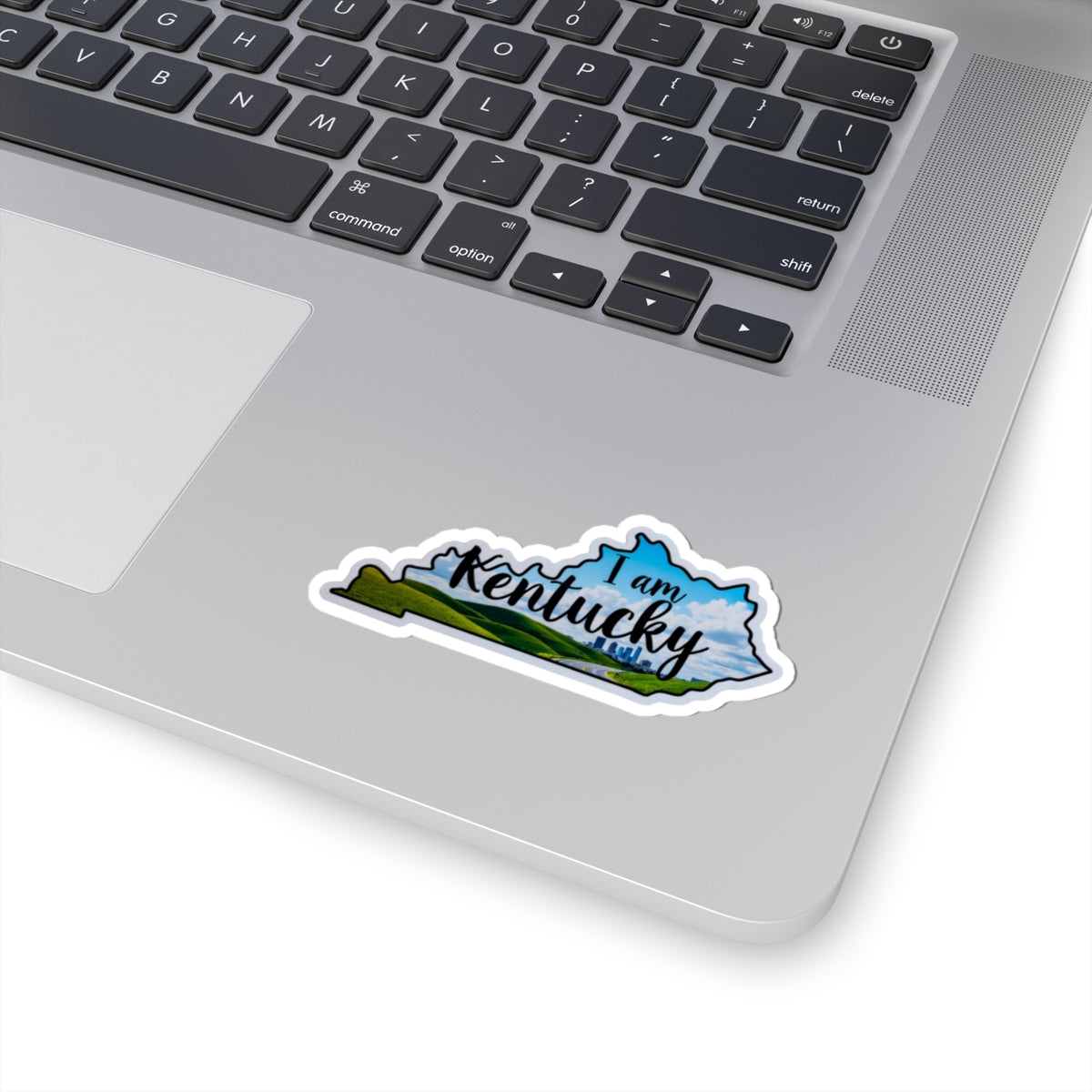 I am Kentucky die-cut sticker on laptop, blue outline and green landscape