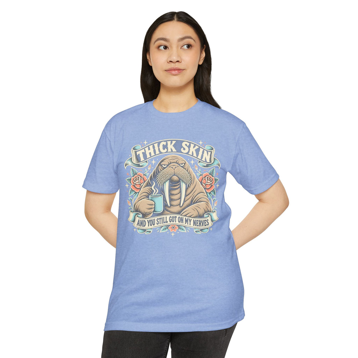 Light blue crew-neck graphic T-shirt with walrus illustration and “Thick Skin” text