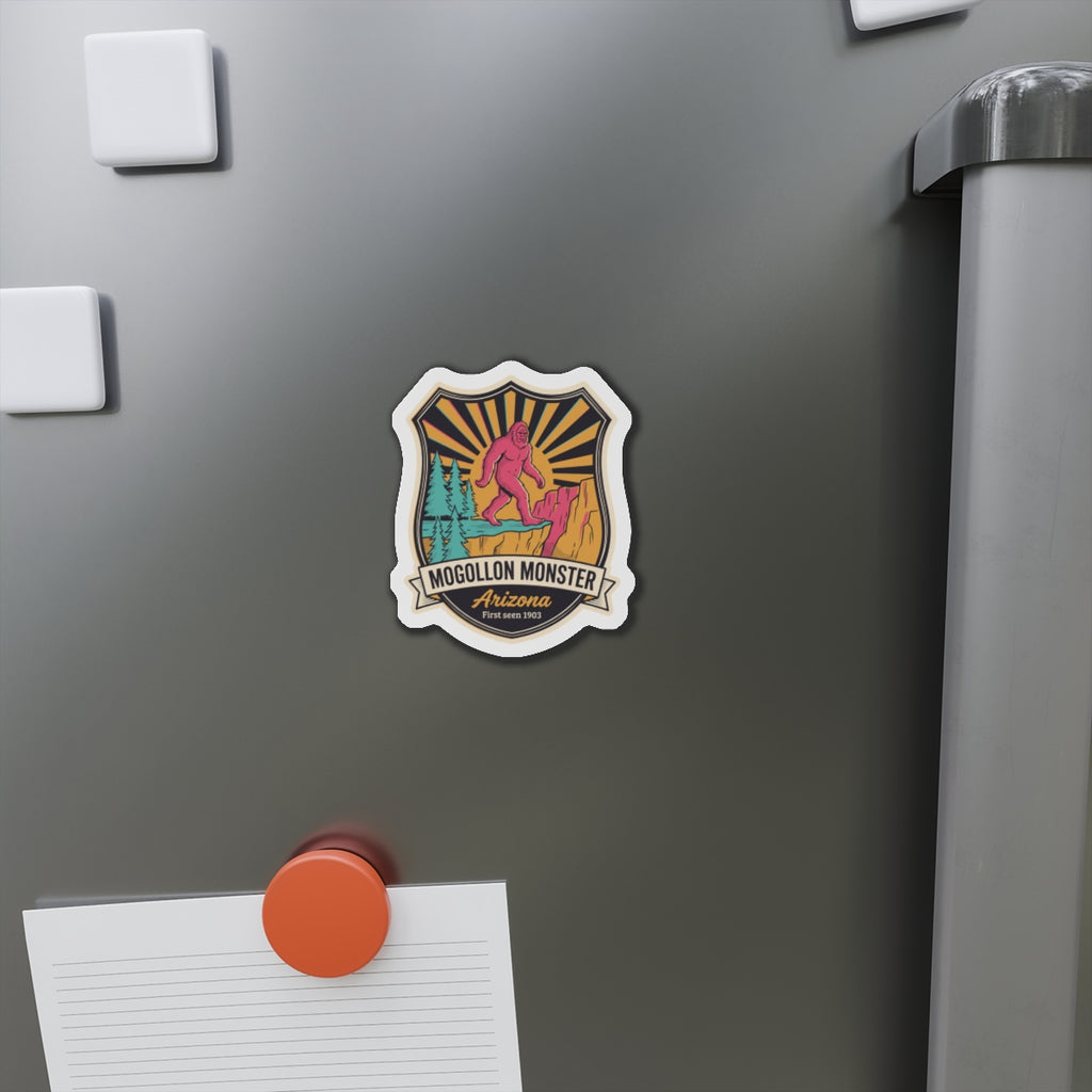 Small die-cut Mogollon Monster Arizona magnet badge on stainless refrigerator surface