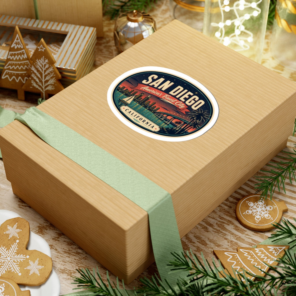 Round San Diego luggage tag sticker on a wrapped gift box with bridge and palm trees