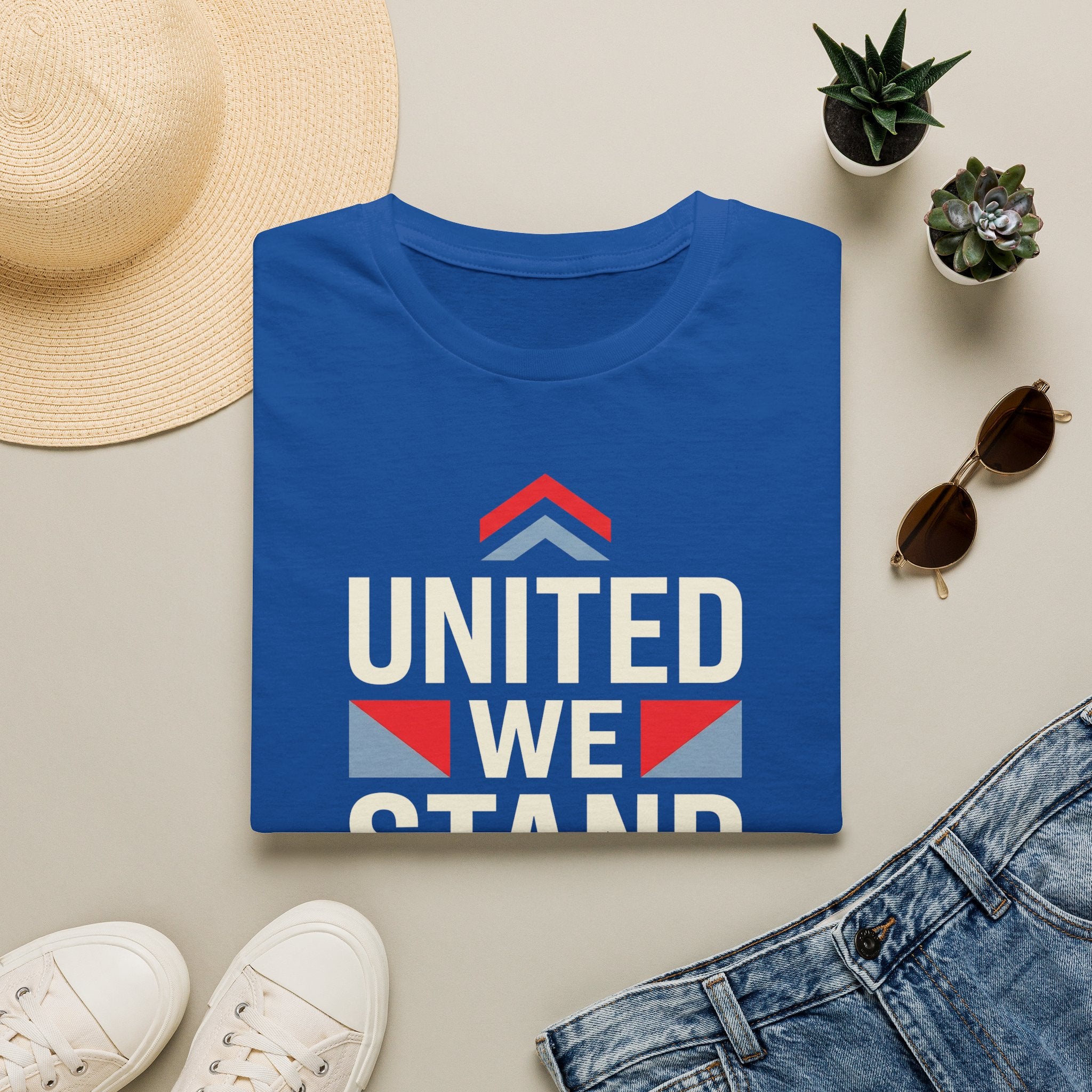 Blue crewneck T-shirt with “UNITED WE STAND” typography graphic on the front