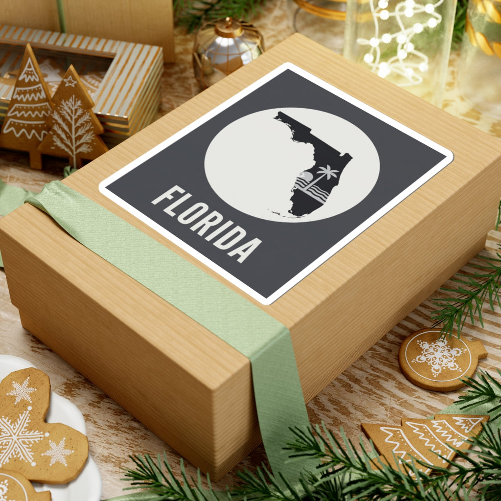 Florida silhouette sticker on wrapped gift with ribbon, circular palm wave and FLORIDA text