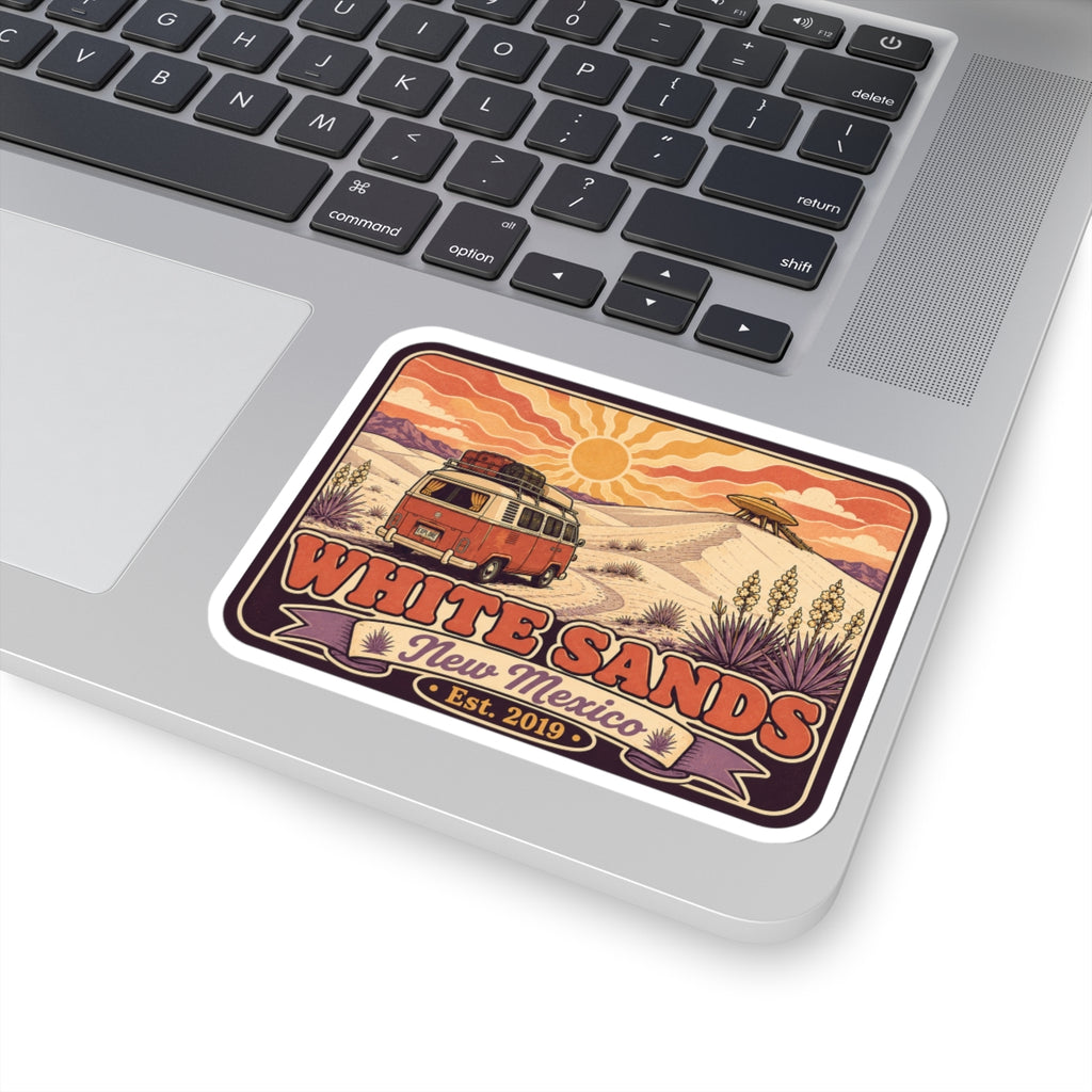 Rounded rectangle sticker on laptop; vintage camper van and White Sands "Est. 2019"
