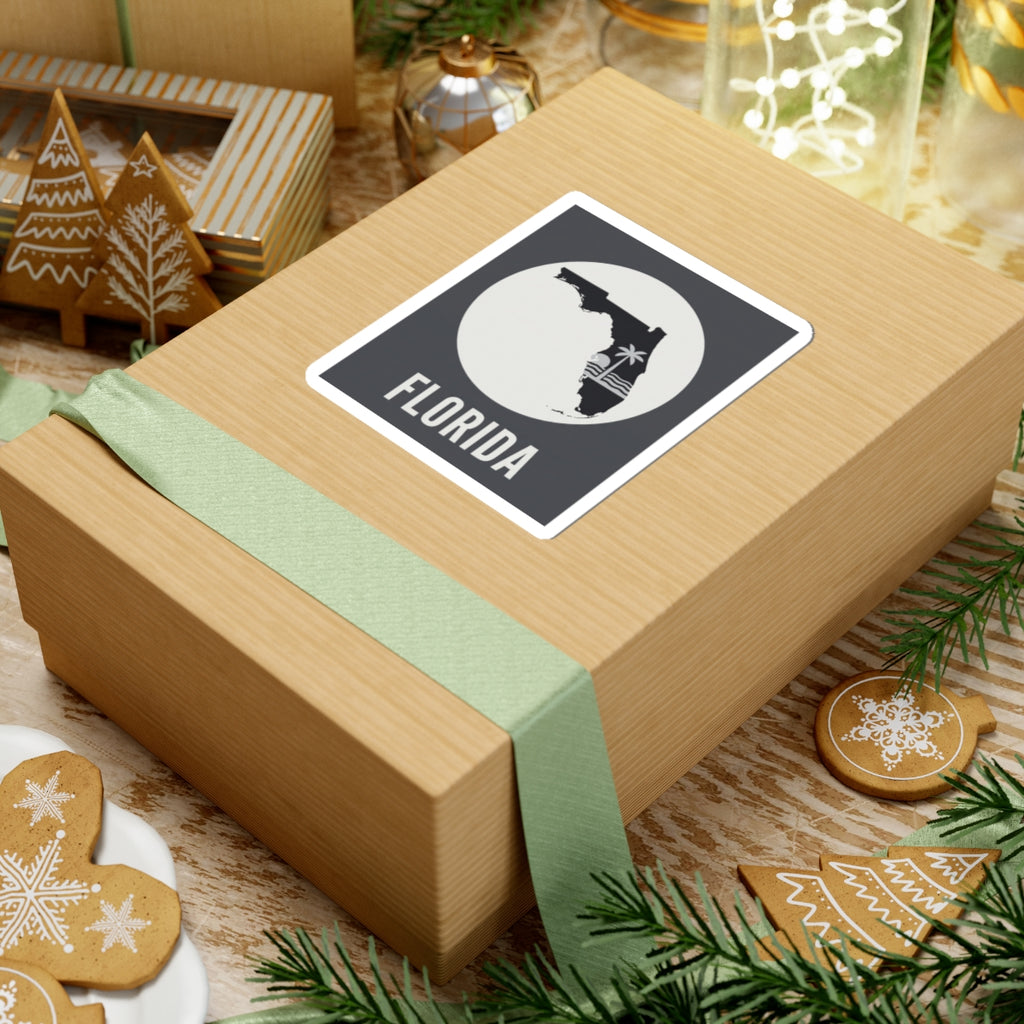 Florida silhouette sticker on wrapped gift, circular palm wave graphic and FLORIDA text