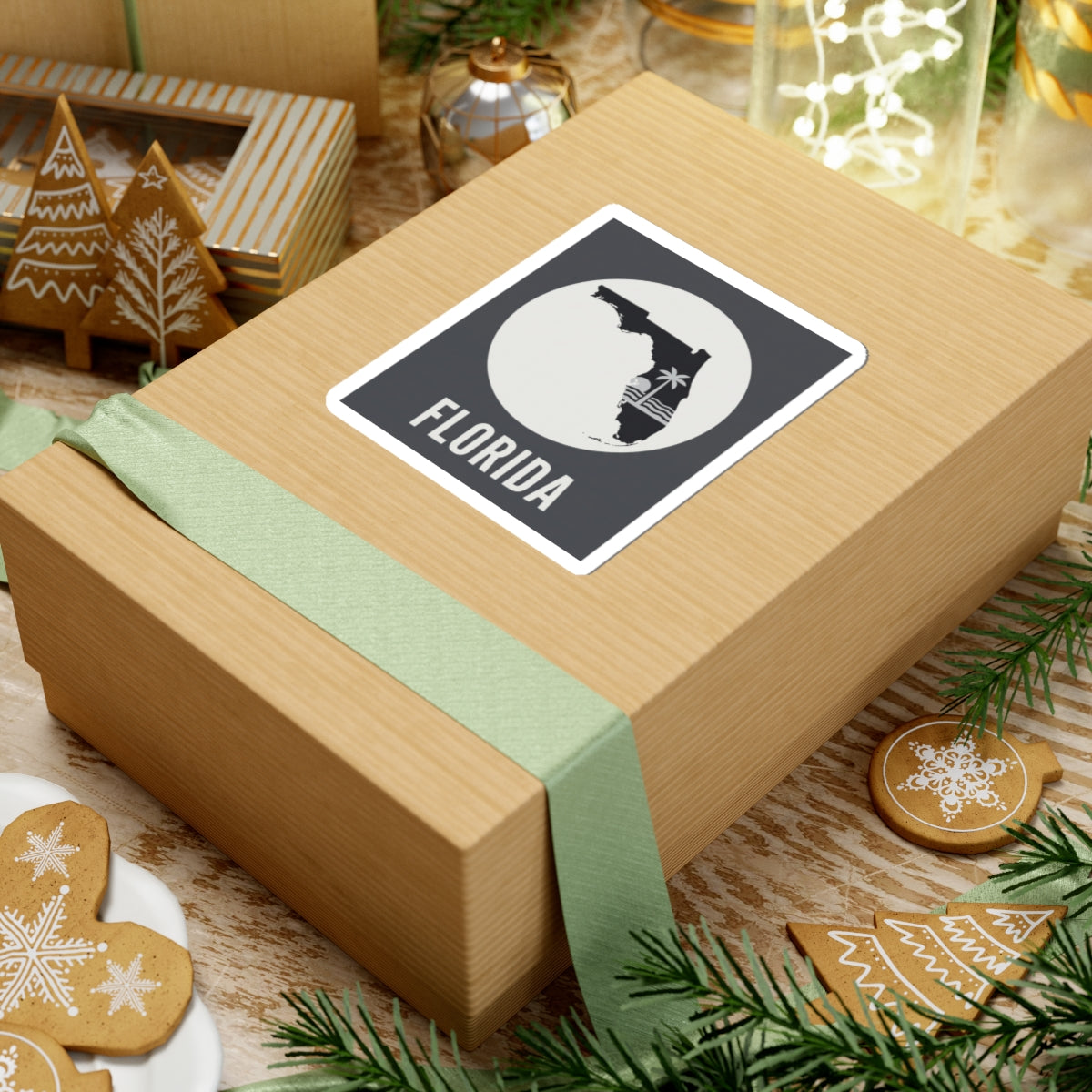 Florida silhouette sticker on wrapped gift, circular palm wave graphic and FLORIDA text
