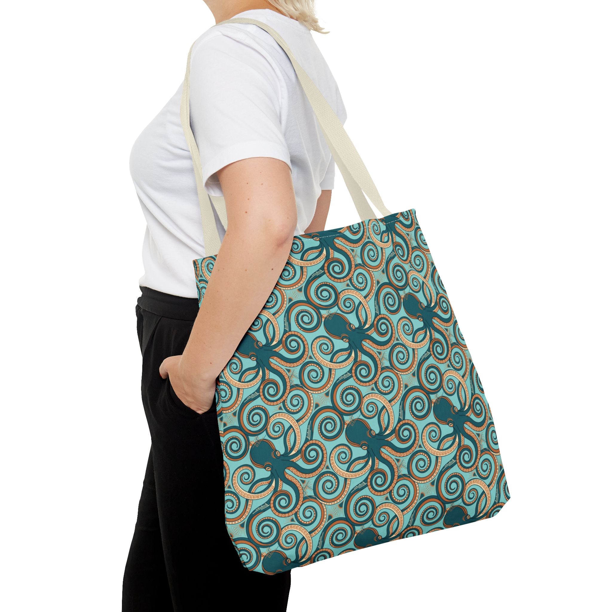 Teal octopus swirl tote bag with navy handles, all-over ocean pattern.