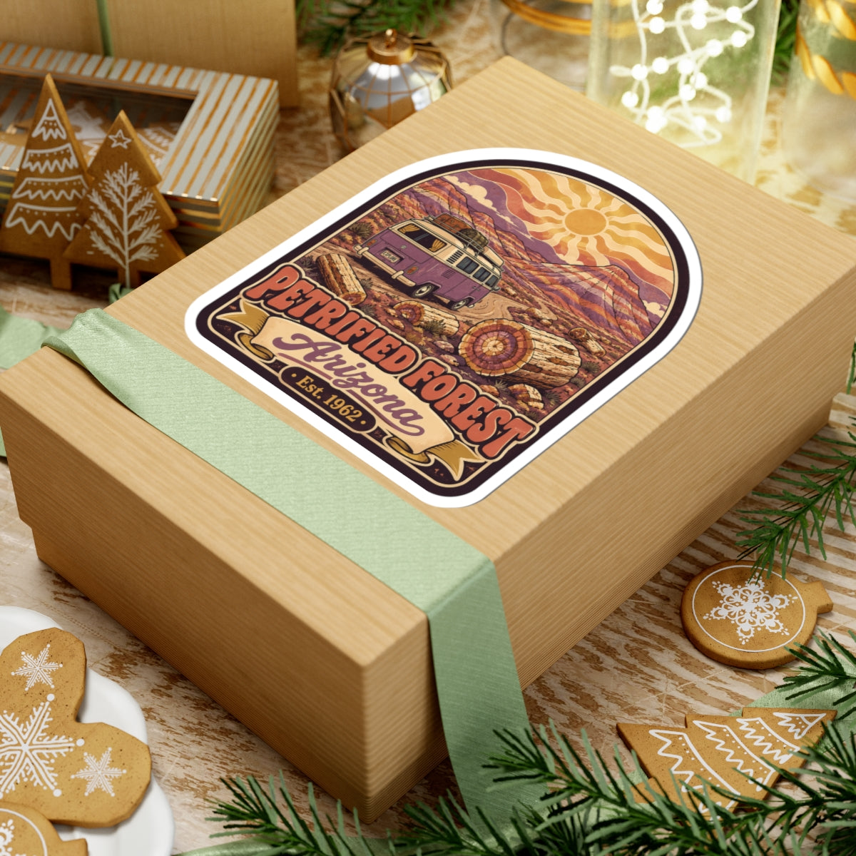 Kiss-cut desert camper van sticker on gift box, showing sun, logs, and 'Petrified Forest Arizona Est. 1962'.