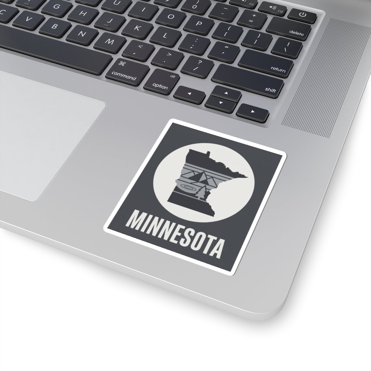Minnesota logo kiss-cut sticker on laptop keyboard with “MINNESOTA” label