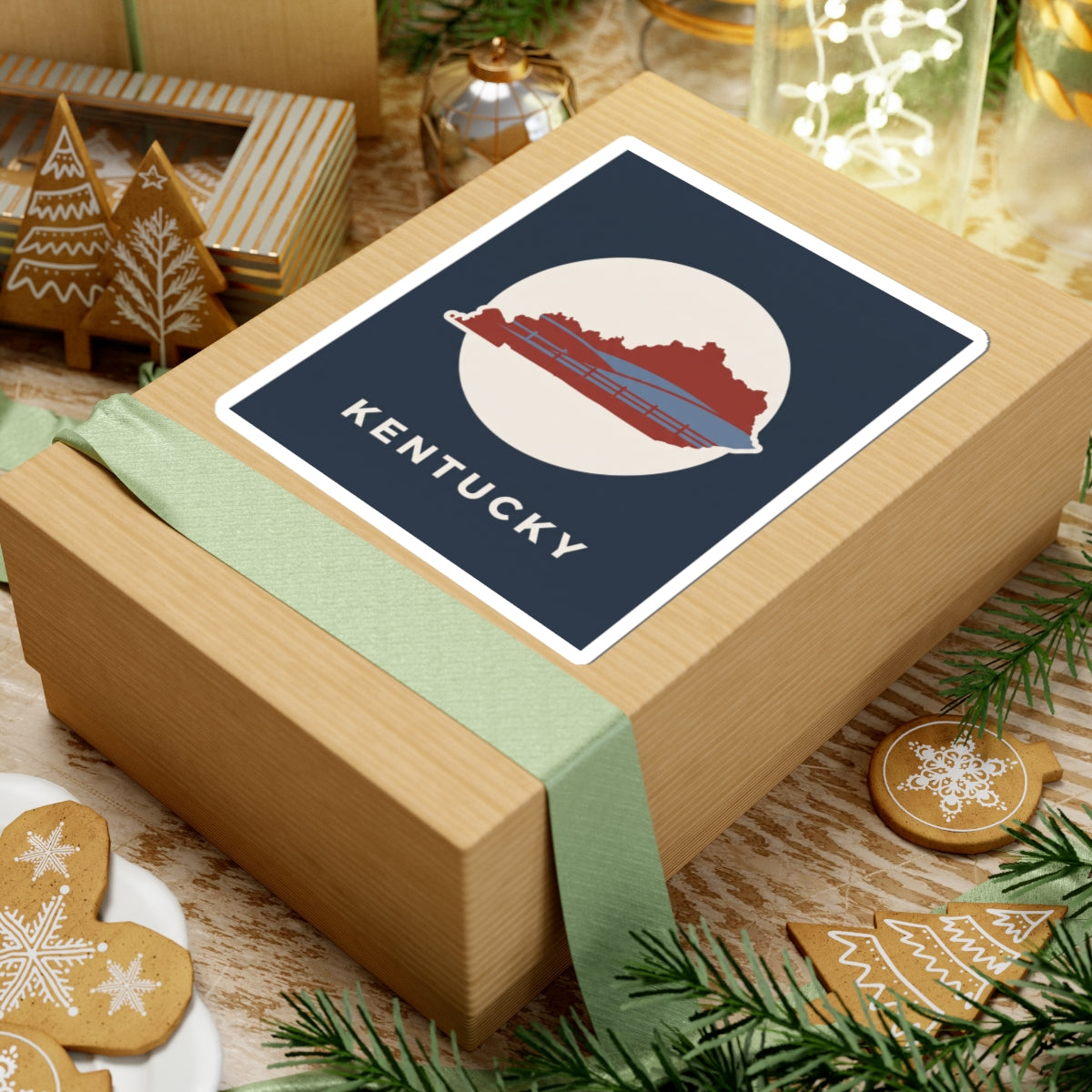 Kentucky travel decal sticker on gift box: navy square with red state outline, bridge, KENTUCKY
