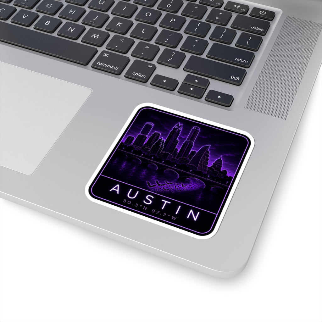 Neon Austin skyline sticker on laptop keyboard; purple “AUSTIN” and 30.30N 97.70W coordinates