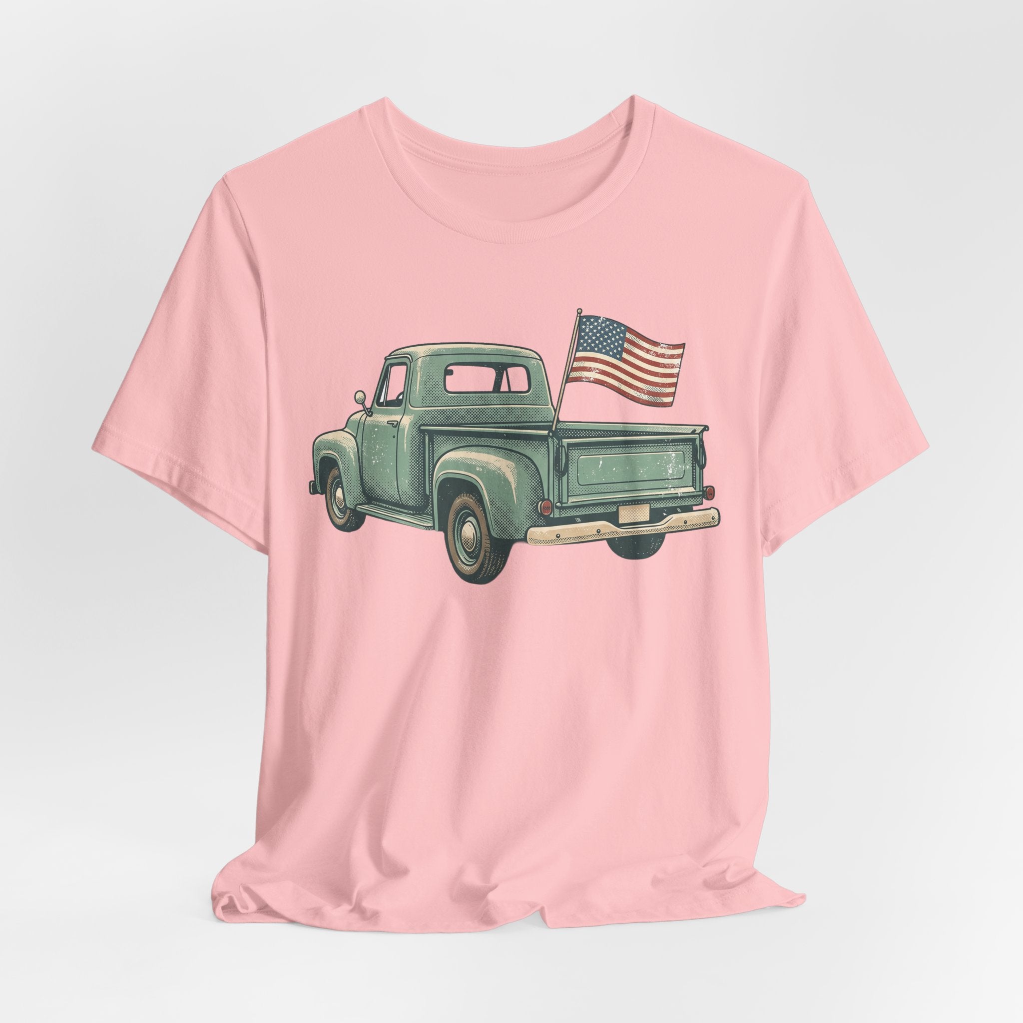 Light pink T-shirt with green pickup truck and American flag graphic