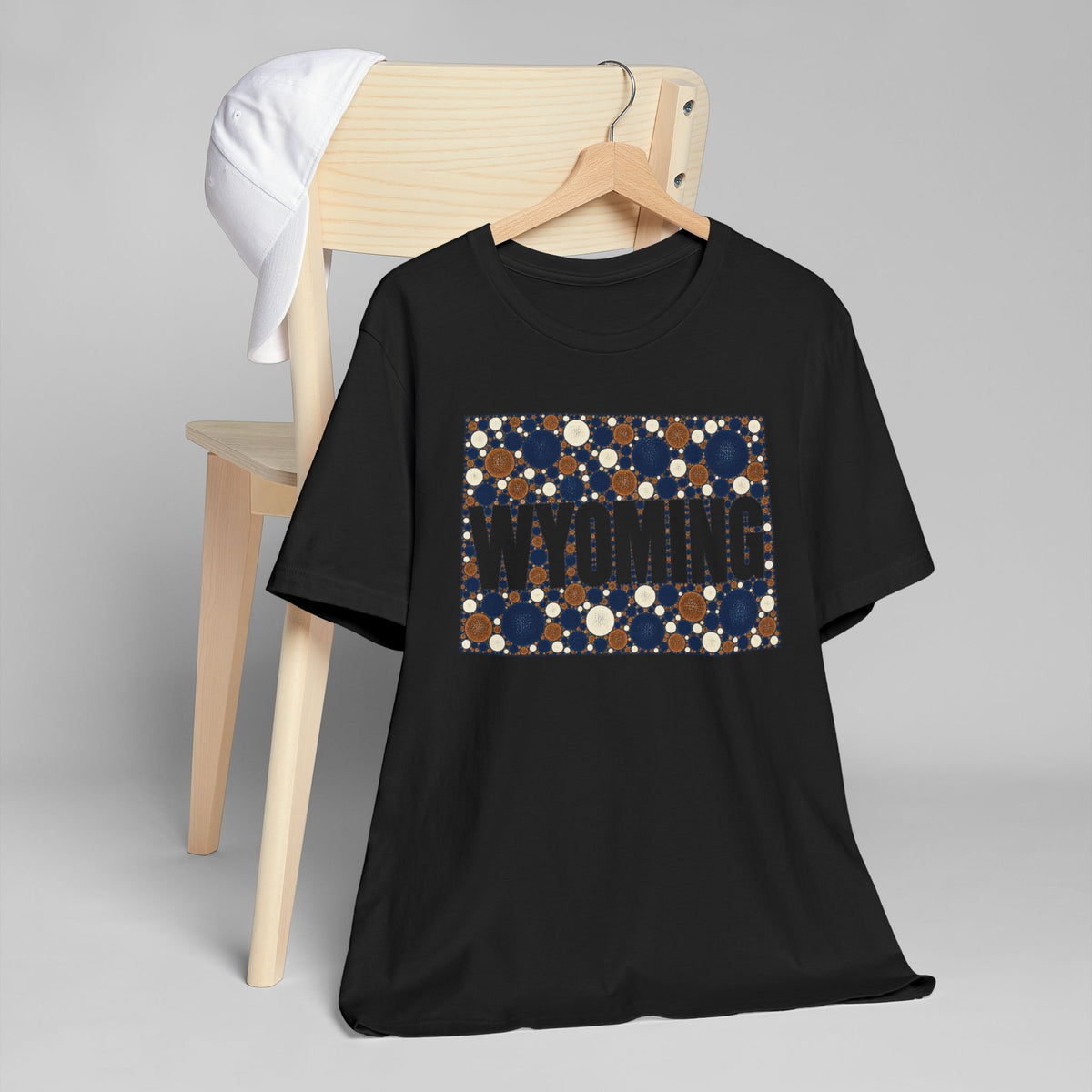 Black crewneck t-shirt with dotted Wyoming map graphic in navy and tan