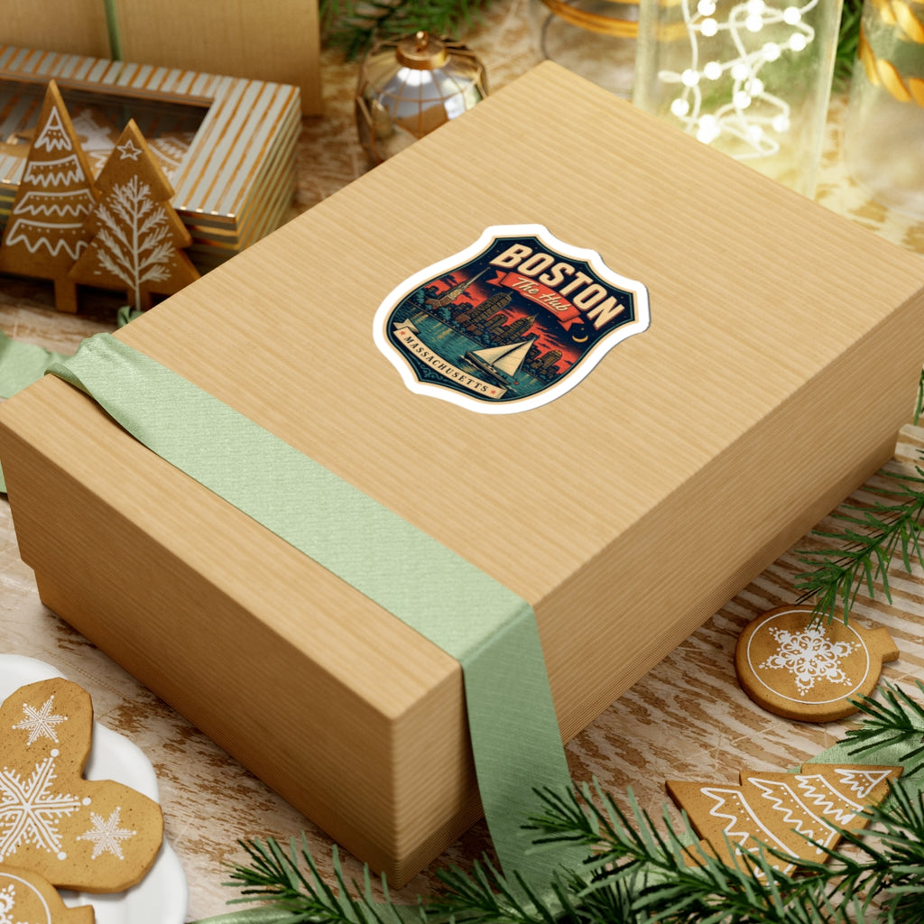 Boston “The Hub” luggage tag sticker on a gift box lid, shield with skyline and sailboat