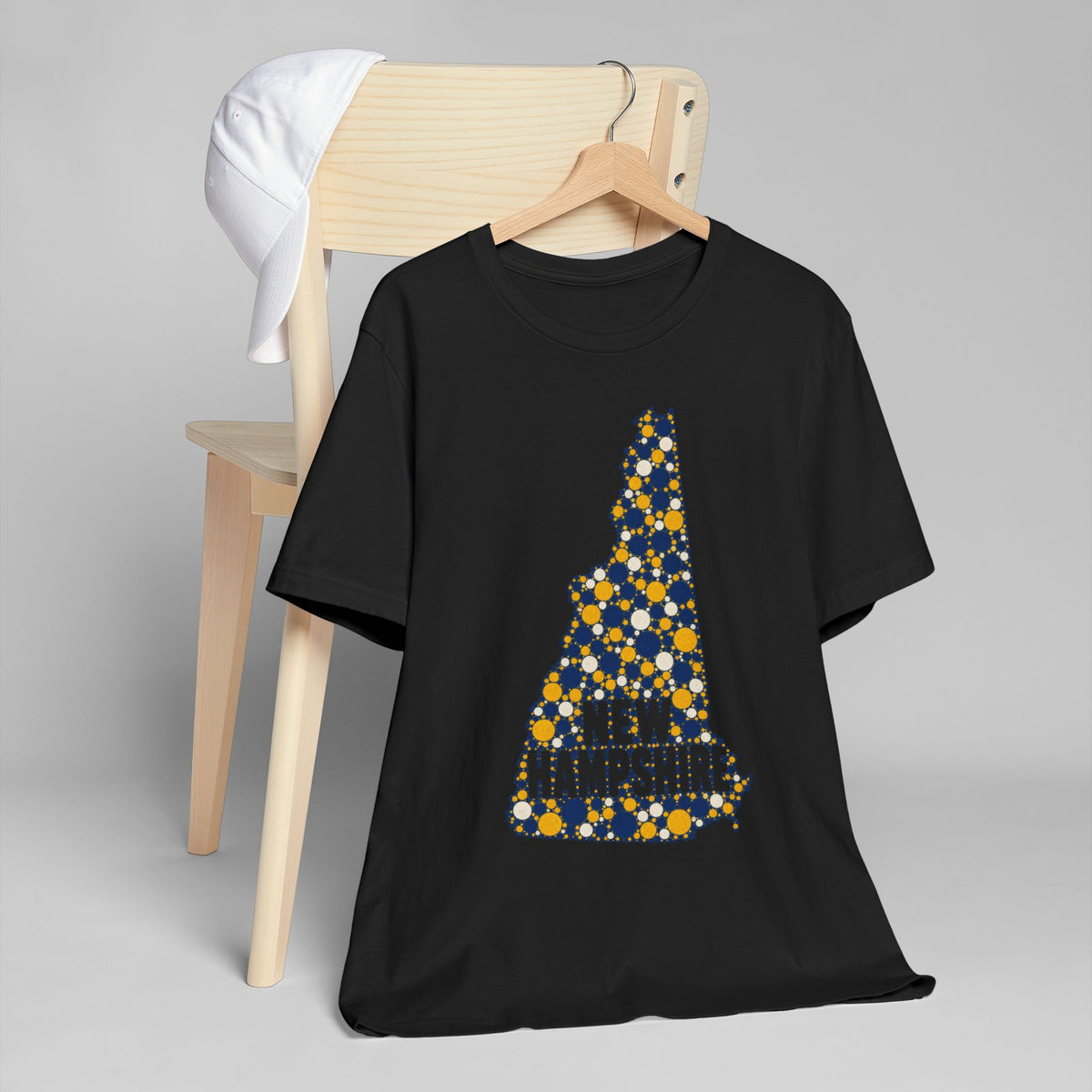 Black T-shirt with blue and yellow New Hampshire tree mosaic graphic