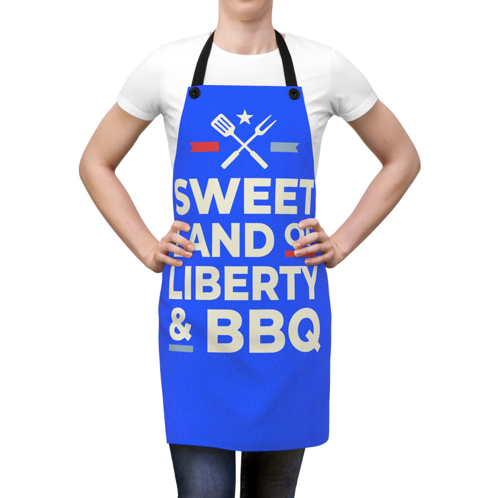 Blue BBQ apron worn over white shirt, 'Sweet Land of Liberty & BBQ' lettering