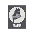 Maine wall art metal sign: dark gray panel, white circle, pine tree silhouette, MAINE lettering