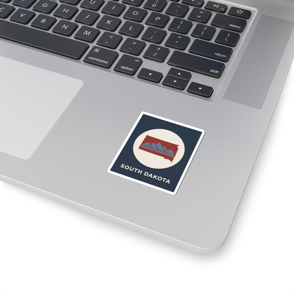 South Dakota map sticker, square retro badge with mountain silhouette, kiss-cut border.