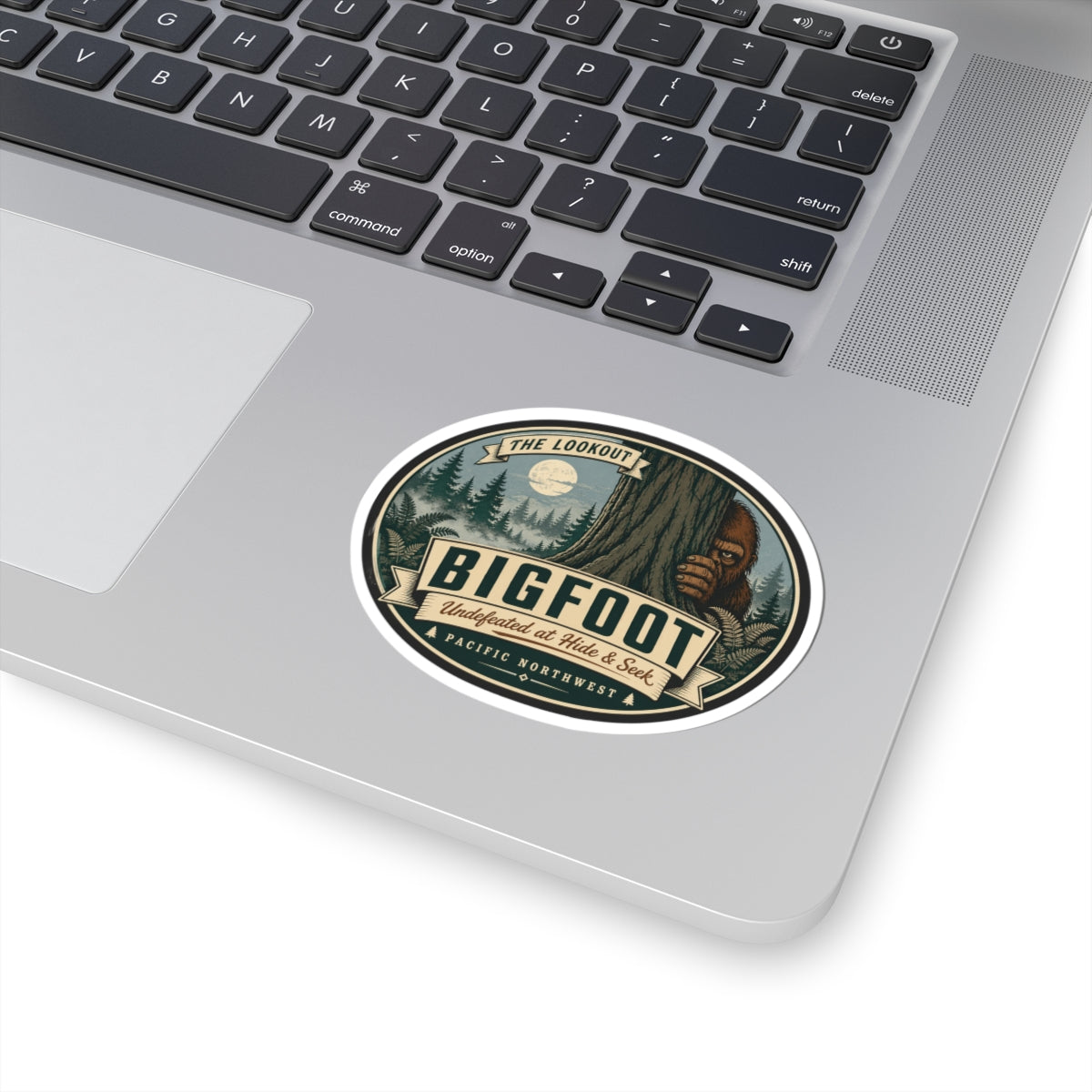 Round kiss-cut Bigfoot outdoor logo vinyl sticker on laptop surface