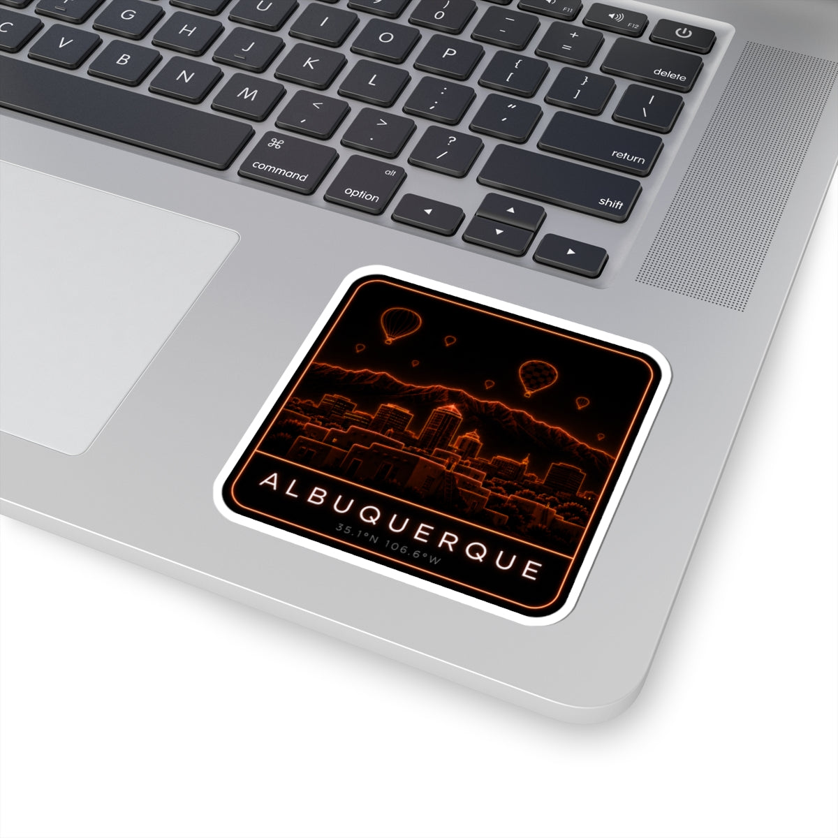 Albuquerque neon skyline kiss-cut sticker on device, orange balloons, city view, and “ALBUQUERQUE”