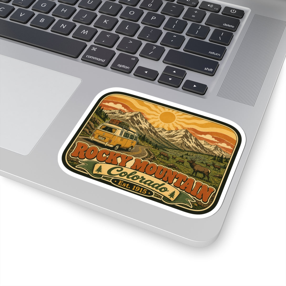 Camper van and mountain landscape sticker reading Rocky Mountain Colorado Est. 1915.