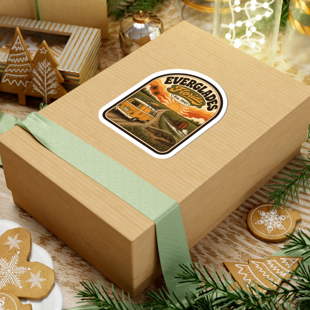 Everglades Florida vintage camper sticker on tan gift box with ribbon, orange van sunset scene