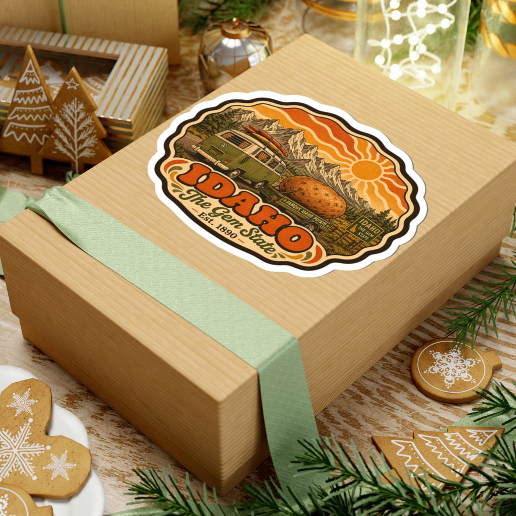 Idaho vintage potato roadtrip sticker on wooden gift box, featuring green van, potato, mountains and sun.