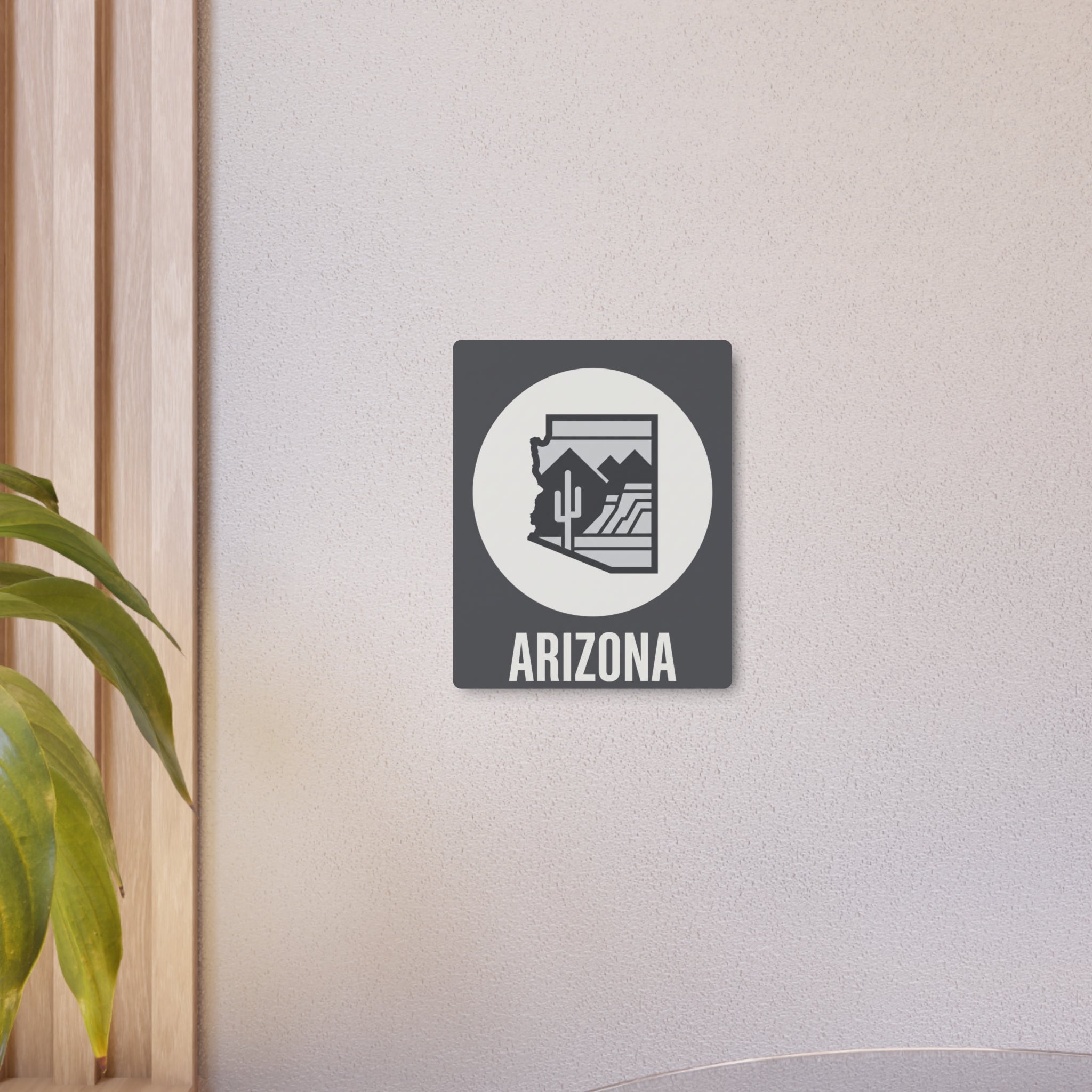 Small dark gray Arizona metal wall sign with white circle and cactus desert silhouette