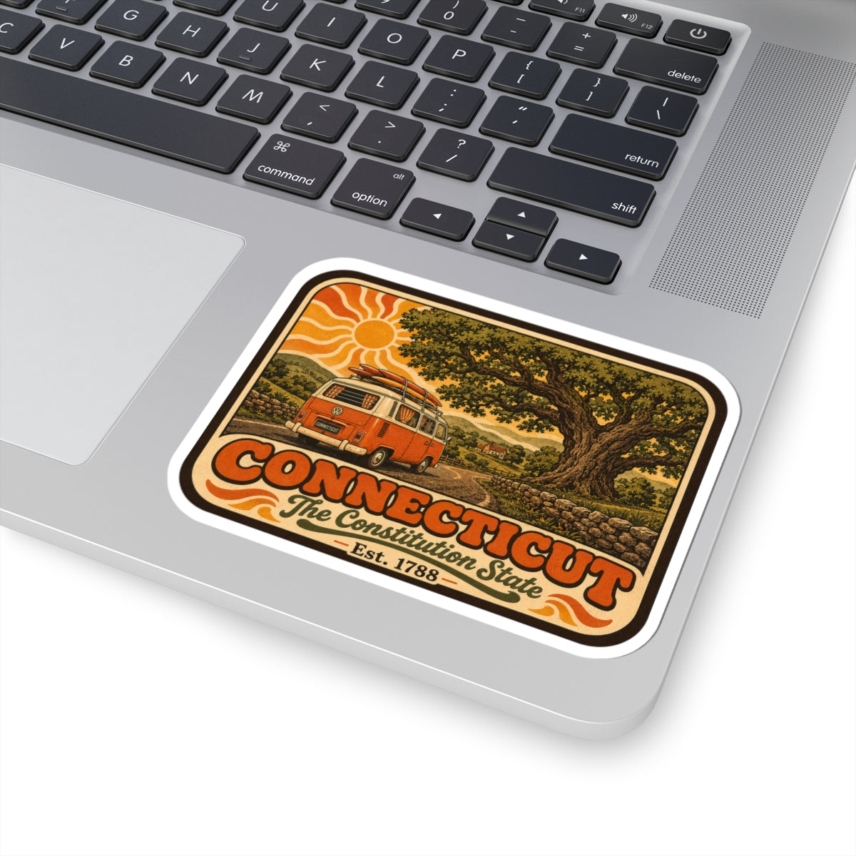 Connecticut travel decal sticker on a laptop lid, featuring camper van and tree art.