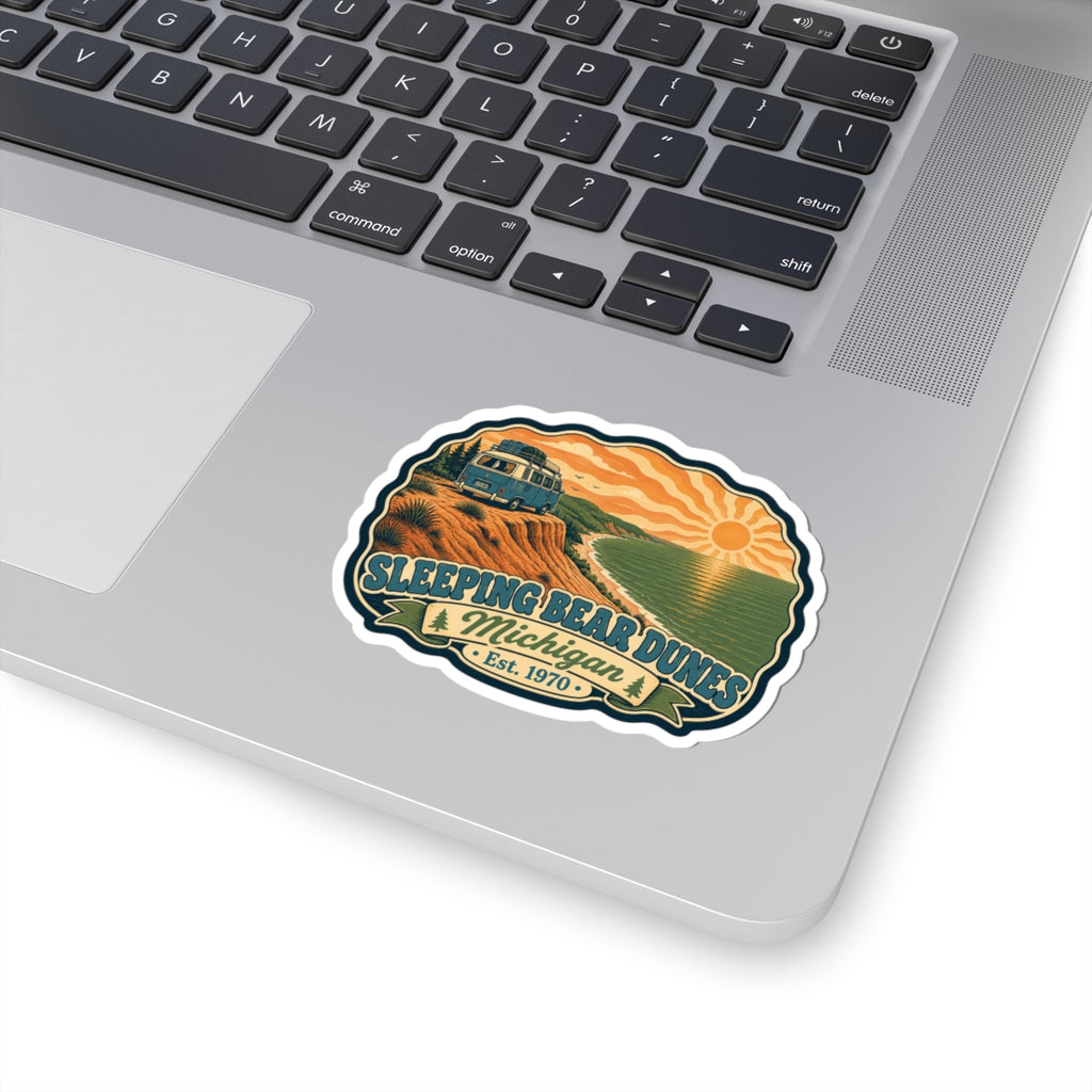 Die-cut sticker design with camper van, dunes, green lake, sunrise, and “Est. 1970” text