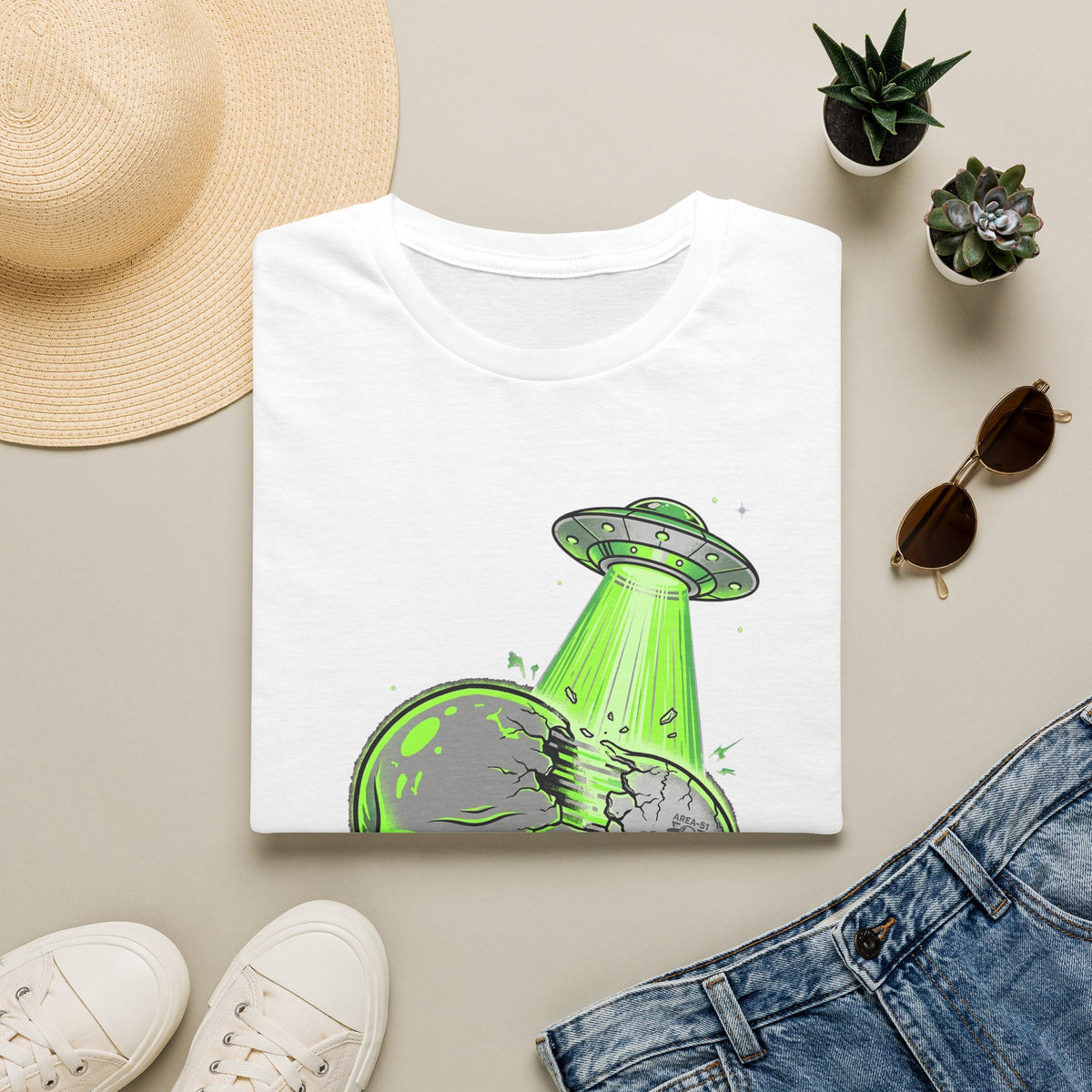 White t-shirt with green UFO abducting alien skull graphic on front