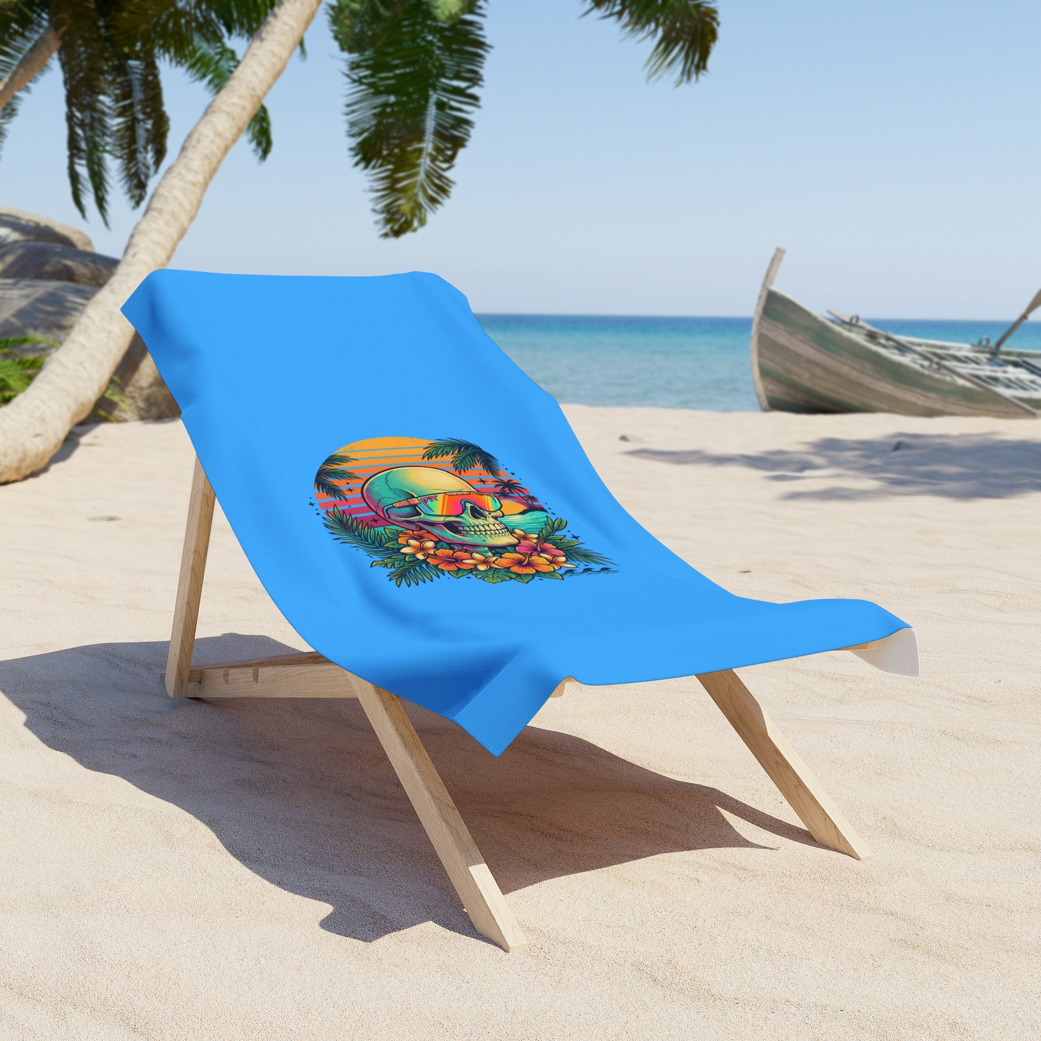 Blue beach towel draped on wooden lounge chair, skull and flower tropical print