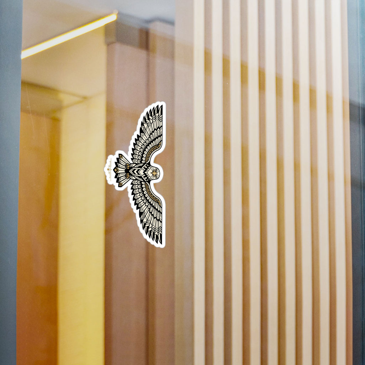 Geometric falcon sticker on wall, black-and-white pattern with gold accent edge