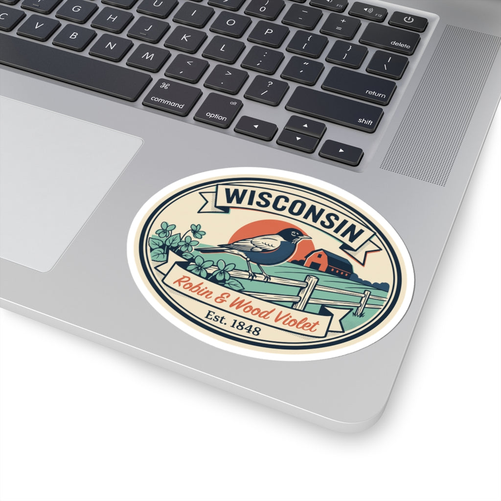 Round Wisconsin badge sticker on laptop lid; robin and house scene with “WISCONSIN” and “Est. 1848”.
