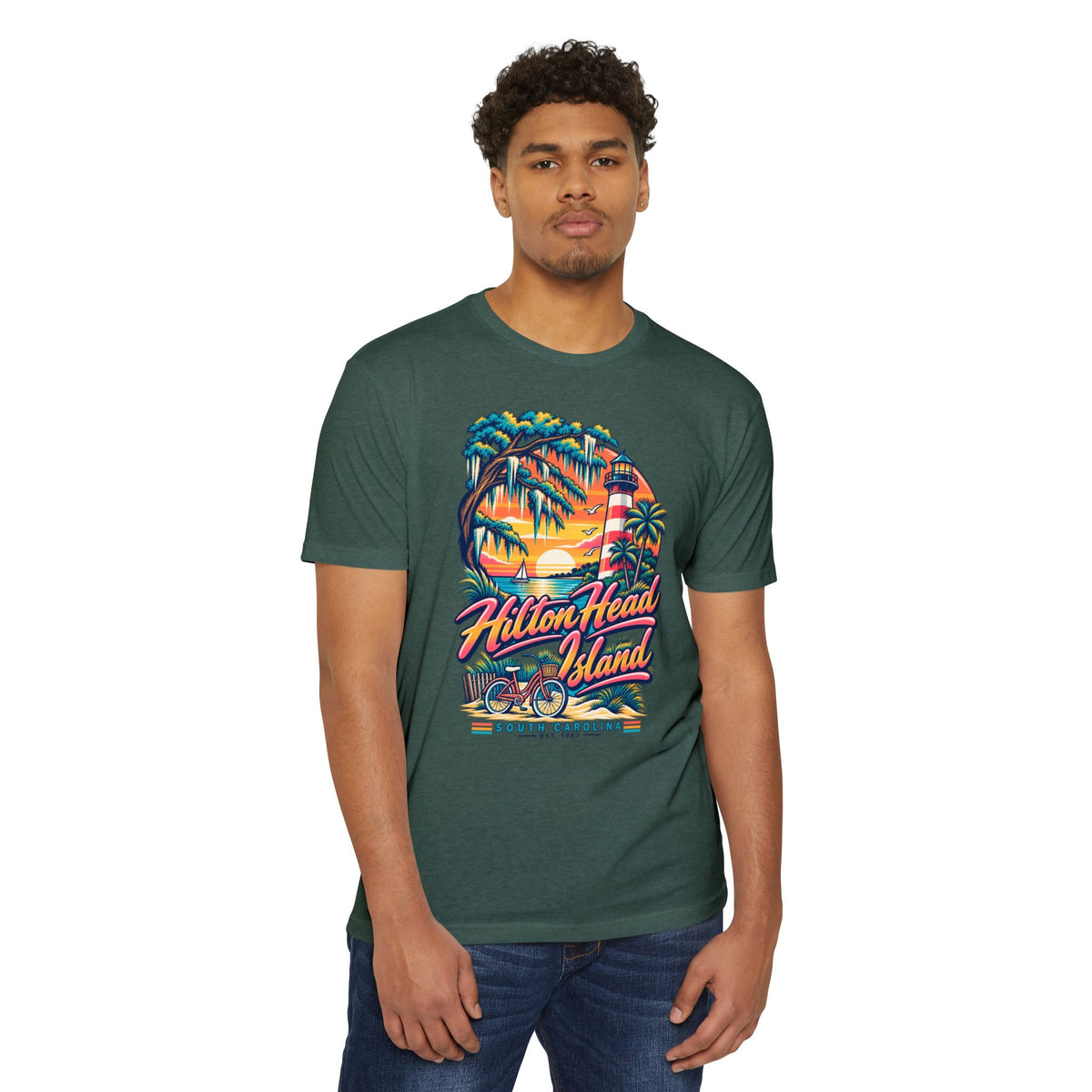 Dark green T-shirt worn by a model with colorful lighthouse, palm trees, and bicycle print