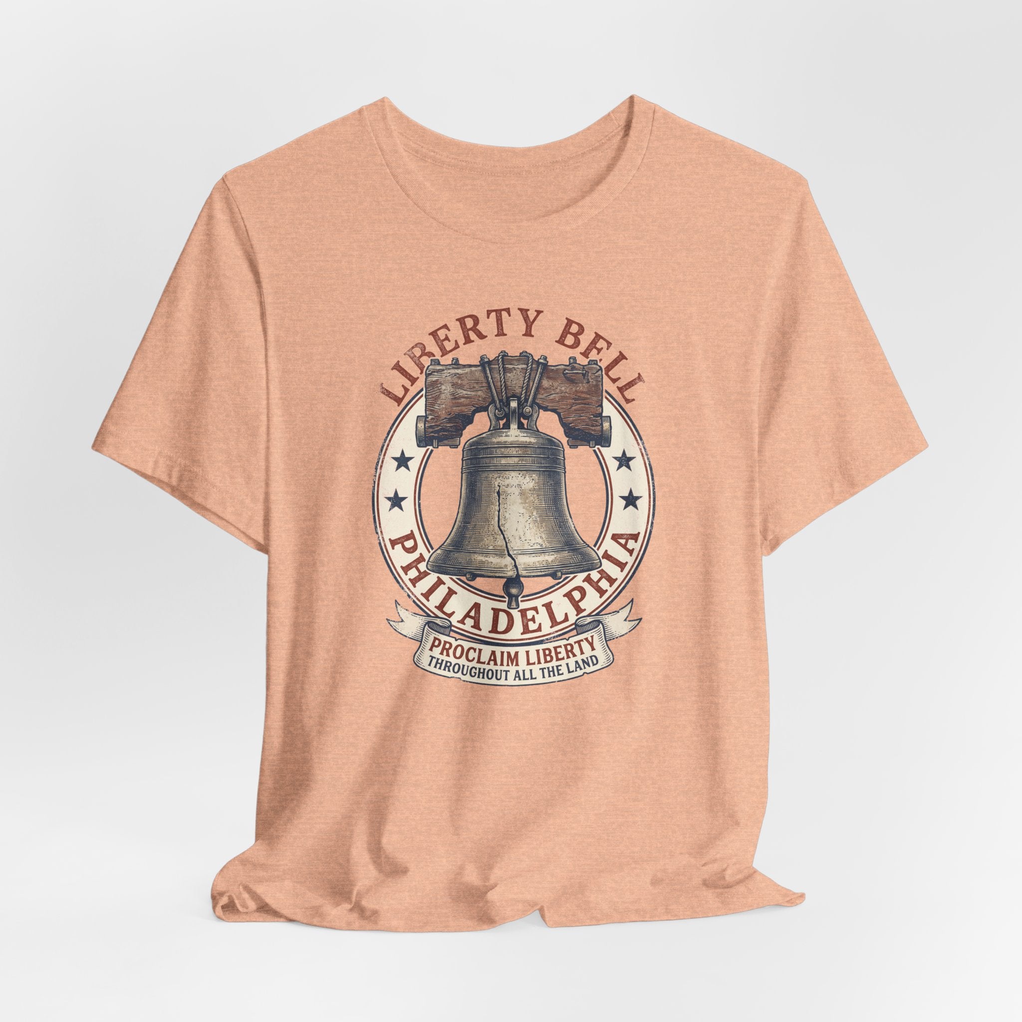 Peach Liberty Bell T-shirt with centered bell graphic in a circular Philadelphia badge