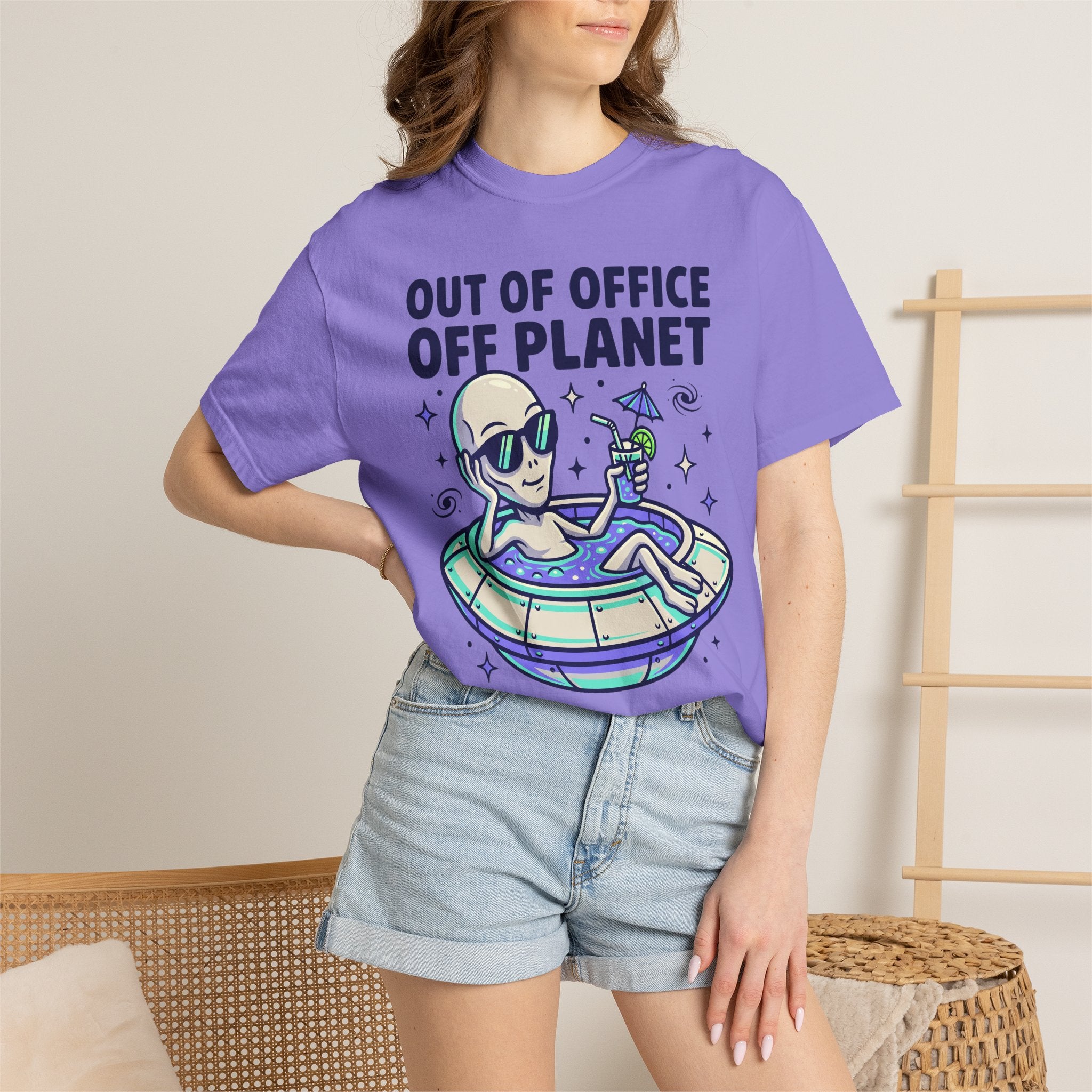 Lavender T-shirt with alien on floatie and 'OUT OF OFFICE OFF PLANET' text graphic