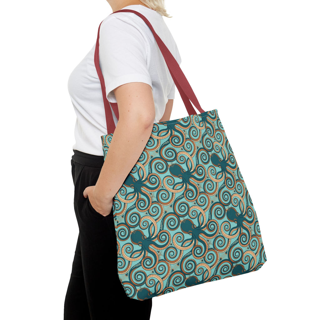 Octopus swirl tote bag carried by strap; teal all-over octopus swirl pattern.