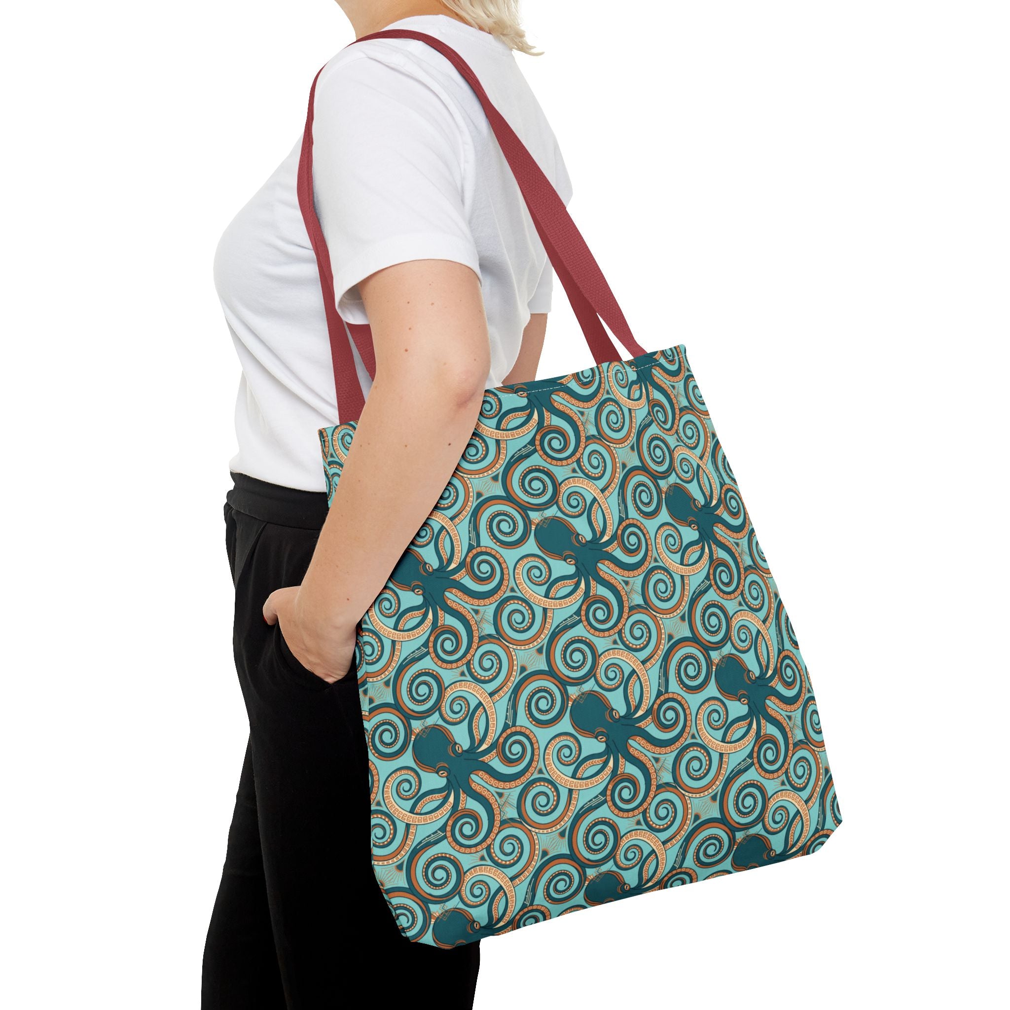 Octopus swirl tote bag carried by strap; teal all-over octopus swirl pattern.