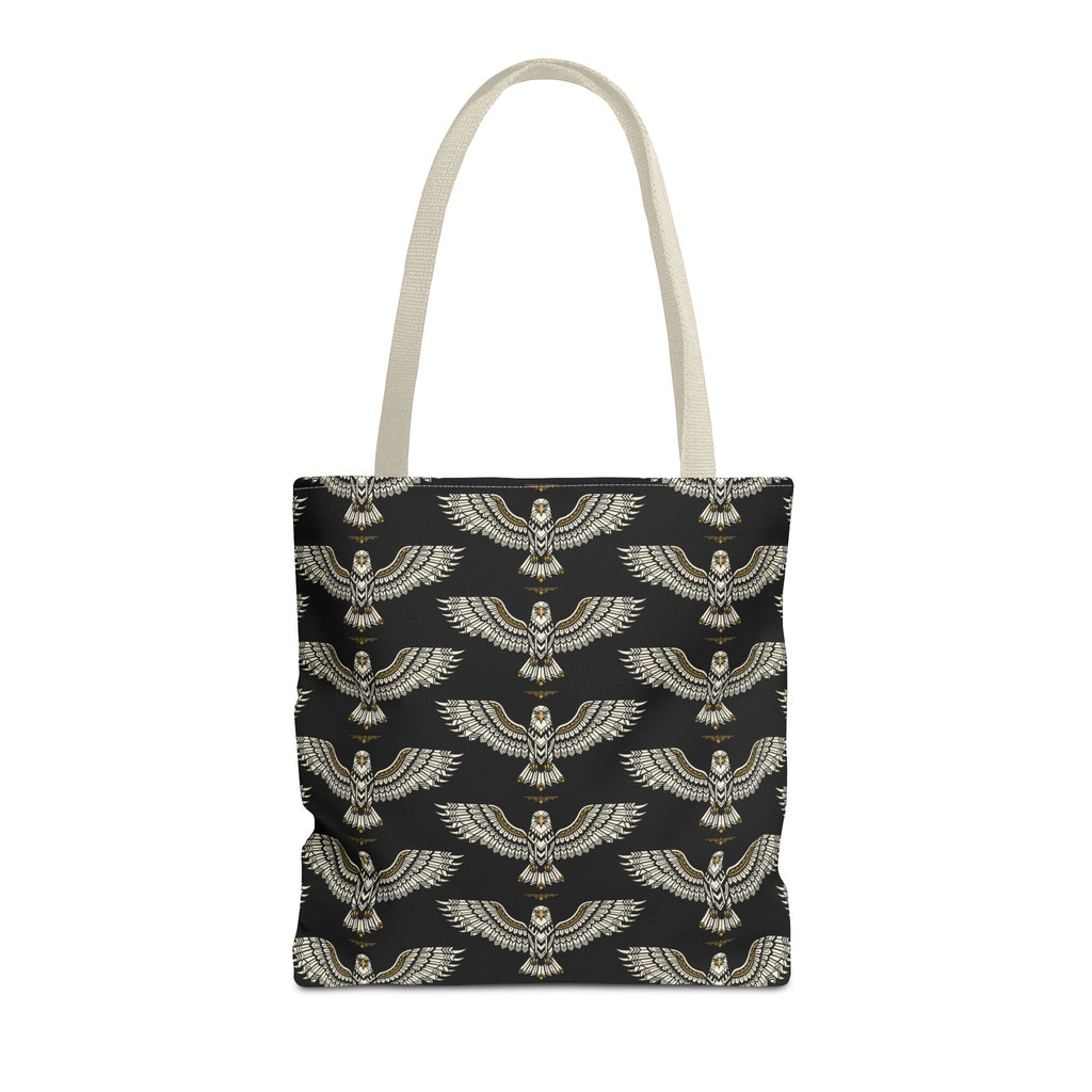 Tote bag featuring winged scarab pattern on black fabric, gold emblems, cream handles