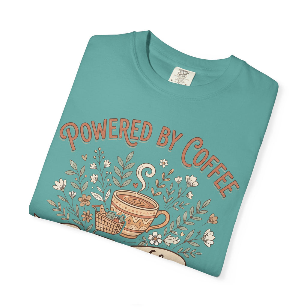 Teal T-shirt with Powered by Coffee text and coffee cup floral graphic