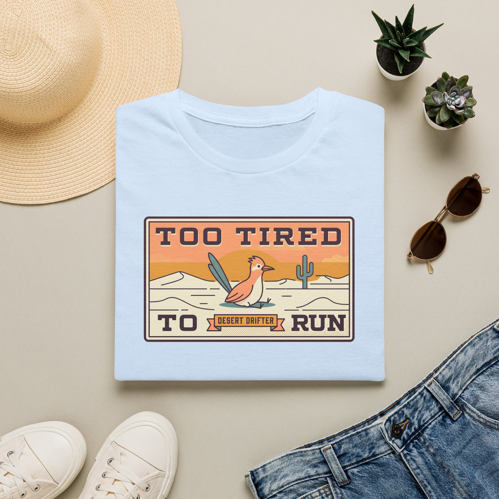 Light blue crew-neck T-shirt with Too Tired To Run desert roadrunner graphic