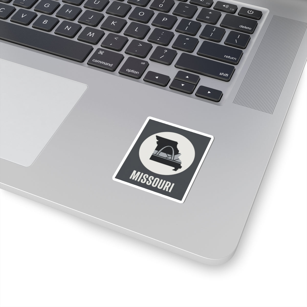 Missouri state outline sticker with Gateway Arch icon and white border, black and gray