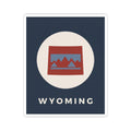 Square Wyoming badge sticker with circular emblem, red/blue mountains, and “WYOMING” text.