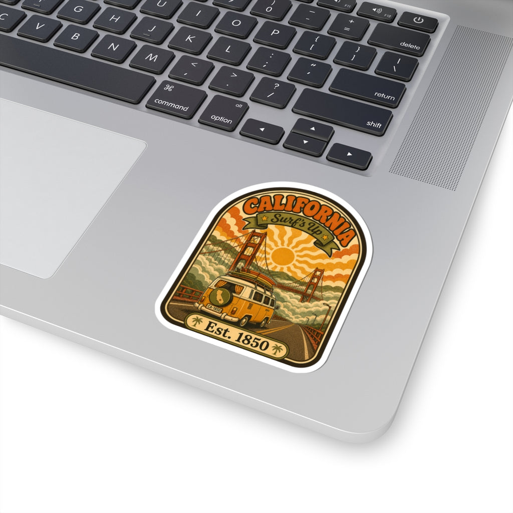 Retro California surf van sticker on a laptop lid with “Est. 1850” text and bridge scene.